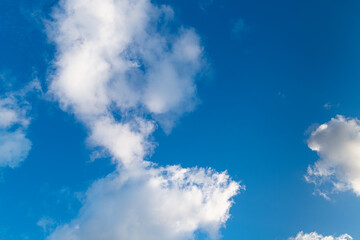 White puffy clouds against a clear blue sky