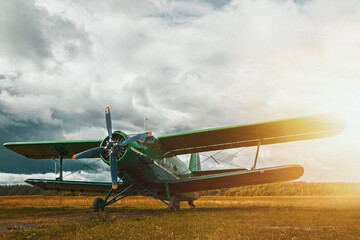 Vintage aircraft preparing for take-off on the background of stormy sky