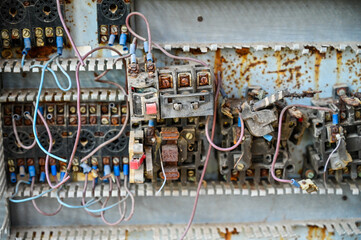 Old electrical installation. Old electrical wiring, switches and fusebox in abandoned factory....