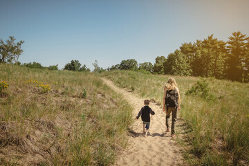 Fototapeta na wymiar Mother and young son walking along a path at Indiana Dunes State Park