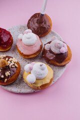 
donuts on a plate on a pink background