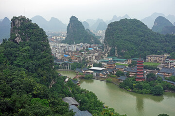 Naklejka premium Guilin city among peaceful atmosphere in the moring mist. Mountians, lake, Pagoda and Lijiang river