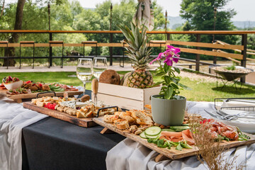 Fototapeta na wymiar Food served on the table in the yard outdoor in sunny summer day ready for celebration party or event - ne people food concept