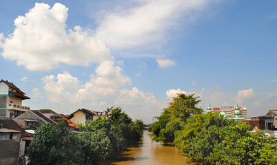 city ​​river with its settlements and beautiful cloudy blue sky in the background