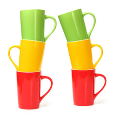 red, yellow and green cups on white background