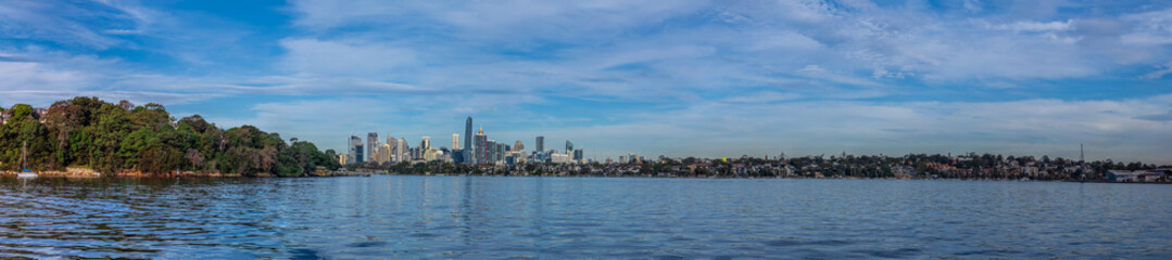 Fototapeta na wymiar Panoramic view of Sydney Harbour and City CBD Skyline of NSW Australia. The beautiful light skies at sunset lovely blue waters 