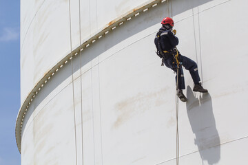 Male worker rope access  inspection of thickness