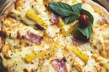 Close up tasty pizza homemade italian food style, pizza cheese ham and pineapple fruit cooking ingredients tomatoes basil on wooden background, Top view of pizza cheese italian food style