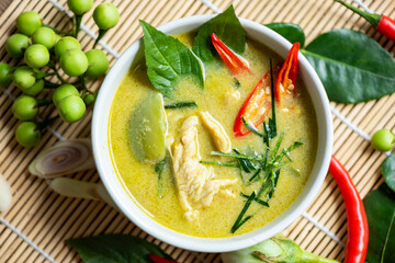 Chicken green curry Thai food on soup bowl with ingredient vegetable herbs and spices pepper chili, Traditional green curry chicken cuisine asian food. Top view