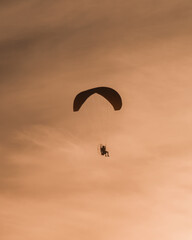 Fototapeta na wymiar paraglider silhouette at sunset