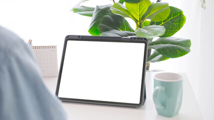 Close up of digital tablet with blank screen working table background for mock up, template