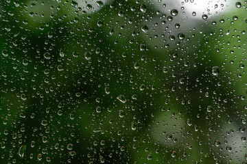 Raindrops on glass. close-up. Dark natural texture. Wet, misted glass. Rain drop. Rain texture 