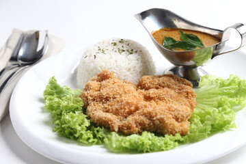 crispy deep fried chicken chop fish cutlet serve with nyonya spicy curry sauce and steam fragrant white jasmine rice and lettuce
