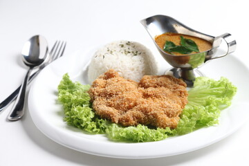 crispy deep fried chicken chop fish cutlet serve with nyonya spicy curry sauce and steam fragrant white jasmine rice and lettuce