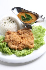 crispy deep fried chicken chop fish cutlet serve with nyonya spicy curry sauce and steam fragrant white jasmine rice and lettuce