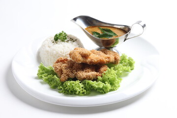 crispy deep fried chicken chop fish cutlet serve with nyonya spicy curry sauce and steam fragrant white jasmine rice and lettuce