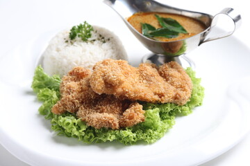 crispy deep fried chicken chop fish cutlet serve with nyonya spicy curry sauce and steam fragrant white jasmine rice and lettuce