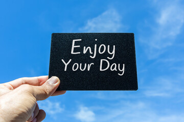 "Enjoy Your Day" card with clouds and sky background.
