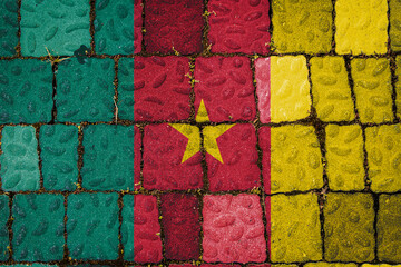 Fototapeta na wymiar National flag of Cameroon on stone wall background. Flag banner on stone texture background.
