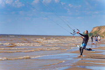 Kiteboarder surfing waves with kiteboard on a sunny summer day.
