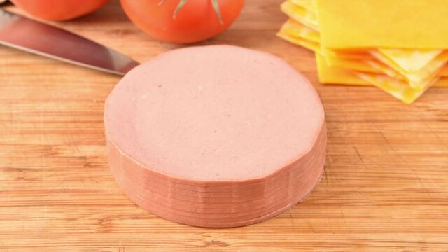 Stacking beef bologna on a cutting board, stop motion animation
