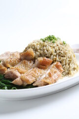 wok garlic olive fried rice with grilled chicken chop cutlet in brown sauce and vegetables on white plate asian halal menu
