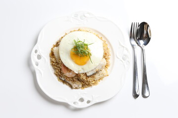 wok garlic fried rice with mixed seafood fish, prawn, squid, octopus, fried egg and vegetables on white plate asian halal menu