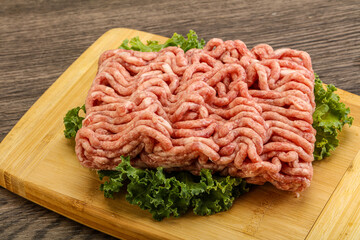 Raw pork minced meat over board