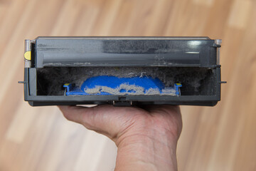 Dust Bin from robot vacuum cleaner with dirty dust powder and hair from the ground contain inside.