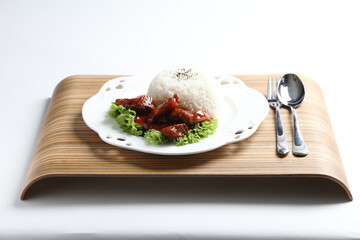 stir fried fresh pork, fish, chicken meat in sweet and sour ketchup tomato sauce serve with steam fragrant white jasmine rice and lettuce