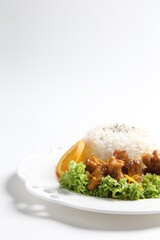 stir fried fresh pork, fish, chicken meat in sweet and sour orange sauce serve with steam fragrant white jasmine rice and lettuce