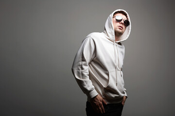 Fototapeta premium Man in Hood and sunglasses. stylish Boy in a hooded sweatshirt