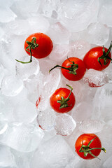 Ripe organic cherry tomato with ice cubes. Ingredients for refreshment tomatoes juice.