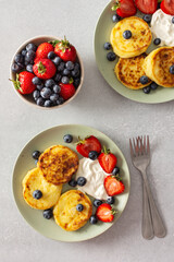 Cottage Cheese Pancake with strawberries, blueberries and sour cream and fresh berries, delicious breakfast, top view