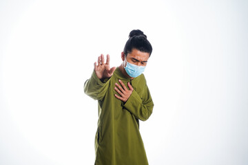 Covid19, the concept of health care and medicine. A young man standing in a face mask with hand gesture "i'm sick", supporting social distance