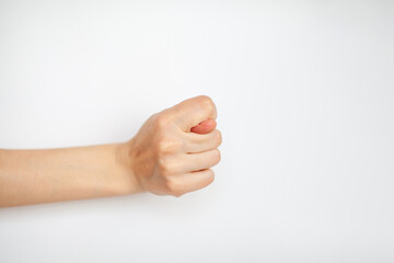 Female hand shows fig gesture, isolated on white background. 