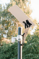 Security camera on a street lamp with reflector