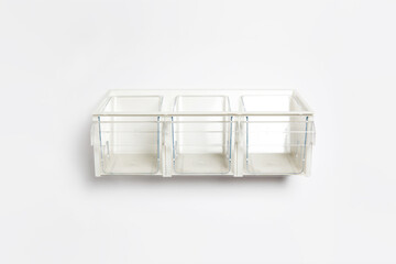 Plastic drawer with pull-out containers isolated on white background. High-resolution photo.