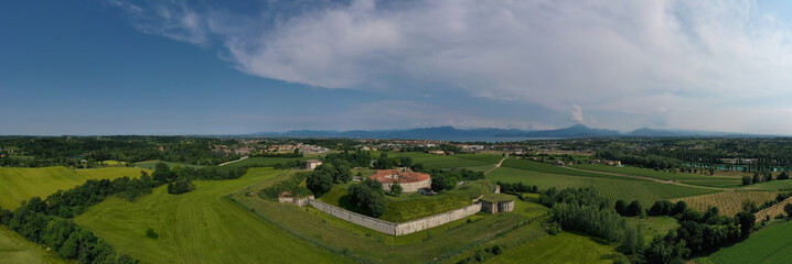 Fort Forte Ardietti on an elevated position overlooking Lake Garda, Italy. Austrian fort on the Italian territory of Peschiera del Garda. Panorama of a military historic fort aerial view.