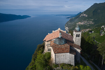 Fototapeta na wymiar Catholic Church Eremo di Montecastello. Top view of the Eremo di Montecastello church. Aerial panorama of Montecastello. Lake Garda, Italy. Aerial view of the church on the mountain.