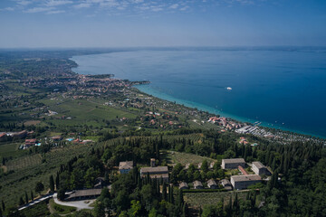 Fototapeta na wymiar Monastery on the Eremo di San Giorgio hill,.Lake Garda, Italy. Aerial view of Eremo di San Giorgio, Bardolino. Aerial panorama Monastery on the hill.