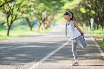 Fototapeta na wymiar Cute asian girl exercise in gardent background