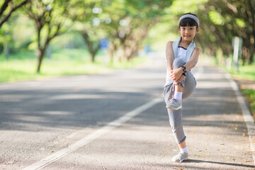 Cute asian girl exercise in gardent background