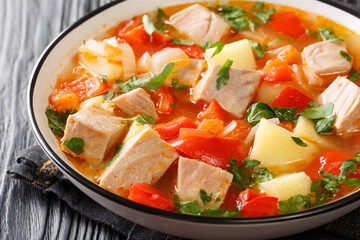 Marmitako Recipe for a Classic Basque Meal made of tuna fish, potatoes, tomatoes and pepper closeup in the plate on the table. Horizontal