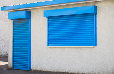 Shop front with blank sign and closed shutter door
