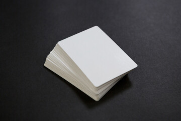 Stack of empty white cards on the black table - Powered by Adobe