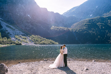 couple in love kissing near mountain lake