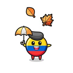 cartoon of the cute colombia flag badge holding an umbrella in autumn