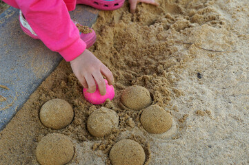 Little hand making semicircle sand on floor sand        