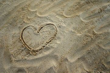 heart drawn in the sand.  Romantic love background.    